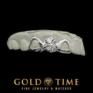 White gold 3 piece grill with a starburst diamond-cut center cap between two open face caps on a dental mold