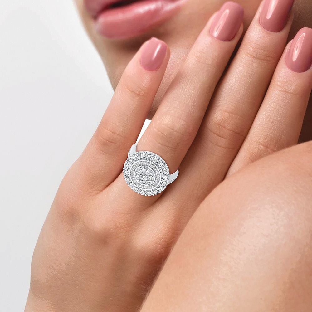 10K white gold round and baguette diamond cluster ring worn on the hand