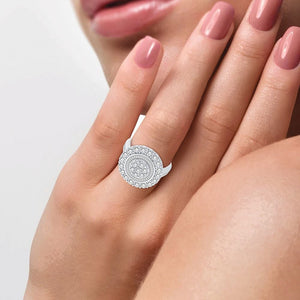 10K white gold round and baguette diamond cluster ring worn on the hand