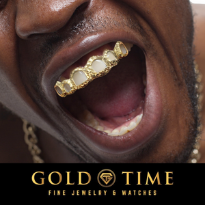 Person wearing yellow gold 6 piece open face trillion cut grillz on the top teeth