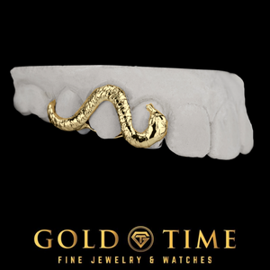 Yellow gold slithering snake grill across three teeth on a dental mold