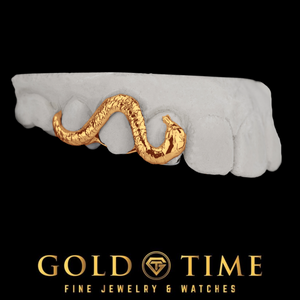 Rose gold slithering snake grill across three teeth on a dental mold