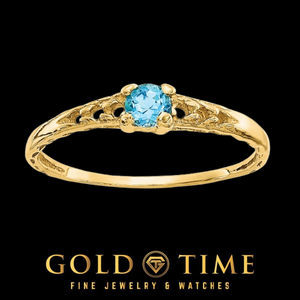14k gold children's ring with a round bright blue Swiss blue topaz in a four prong setting