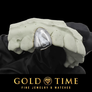 Silver single tooth grillz cap with a state engraving, fitted to a dental mold on a black background