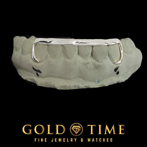 White gold 6 tooth grill with a solid tip bar and open J-hook canines on a bottom mold