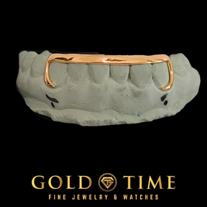 Rose gold 6 tooth grill with a solid tip bar and open J-hook canines on a bottom mold