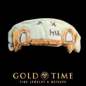 A rose gold open face fang grillz, with black hand-written markings on the front. The image is set against a solid black background with the brand logo 'GOLD TIME FINE JEWELRY & WATCHES' at the bottom.
