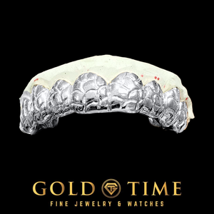 A custom silver dental grill on a white dental mold, displayed against a solid black background with the Gold Time logo at the bottom.