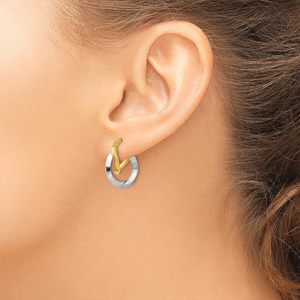 14K Two-Tone Gold Double Twisted Hoop Earrings in yellow and white gold, worn on the ear