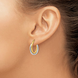 14K Two-Tone Gold Intertwined Double Hoop Earrings in yellow and white gold, worn on the ear