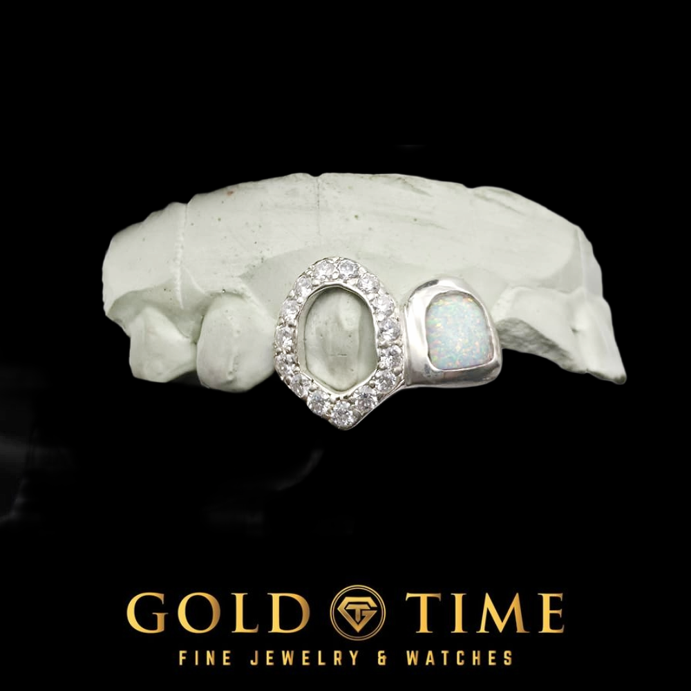 White metal double cap grillz with a synthetic opal cap and an iced open face fang on a dental mold, Gold Time