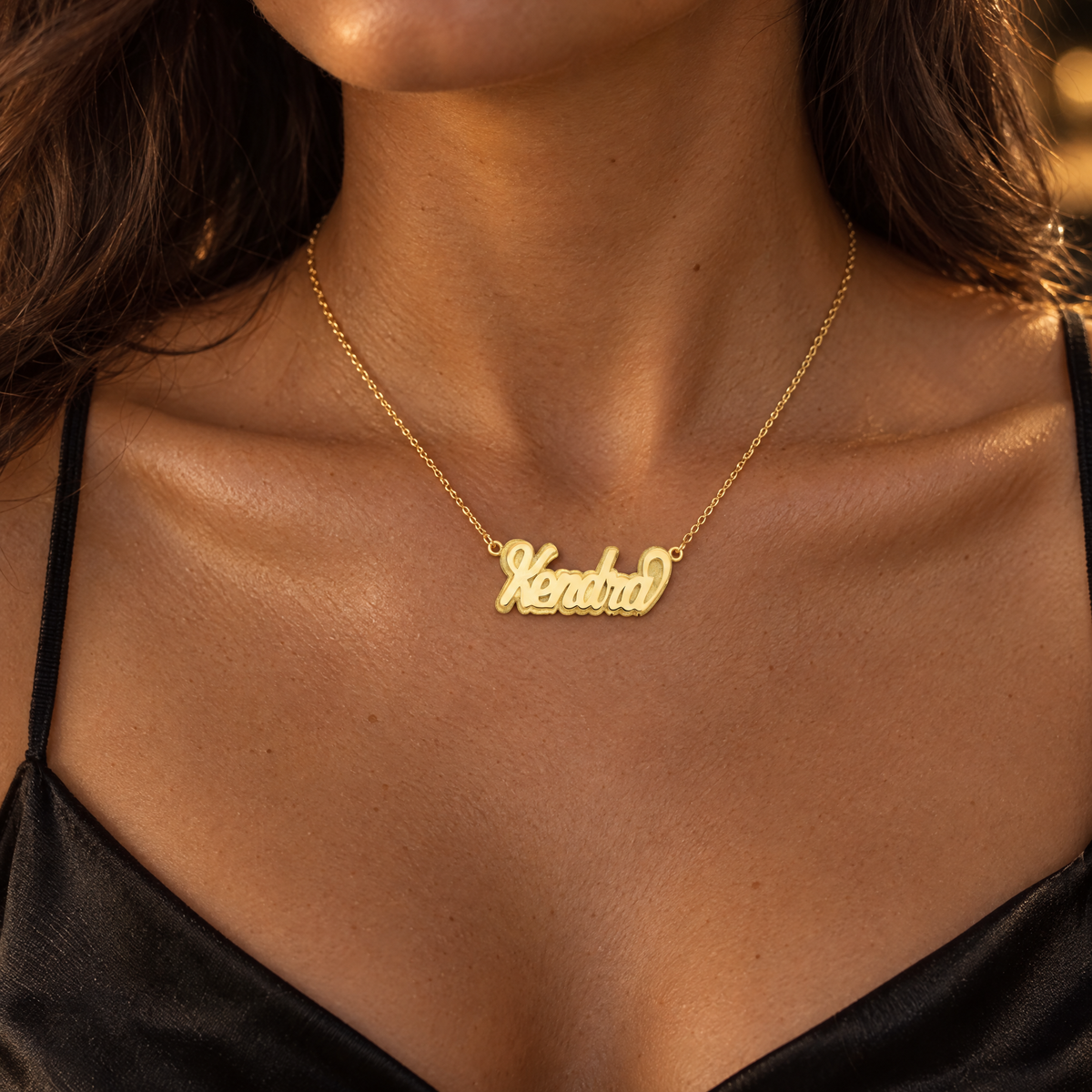 Yellow gold 3D script nameplate necklace reading Kendra, worn by a woman, lifestyle photo, Gold Time