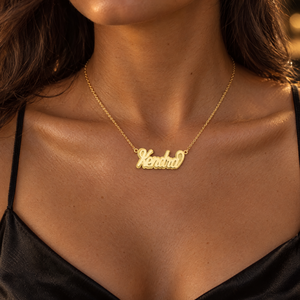 Yellow gold 3D script nameplate necklace reading Kendra, worn by a woman, lifestyle photo, Gold Time