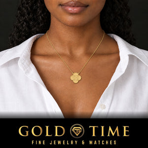 Woman in a white shirt wearing the yellow gold clover monogram necklace engraved with three initials, Gold Time