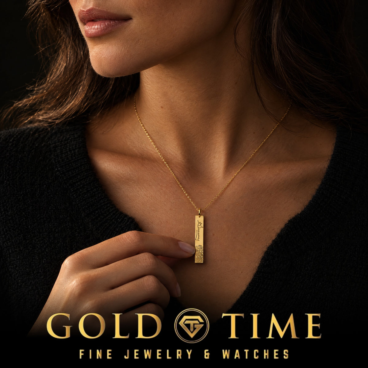 Woman in a black sweater holding her engraved fingerprint and signature bar necklace, Gold Time