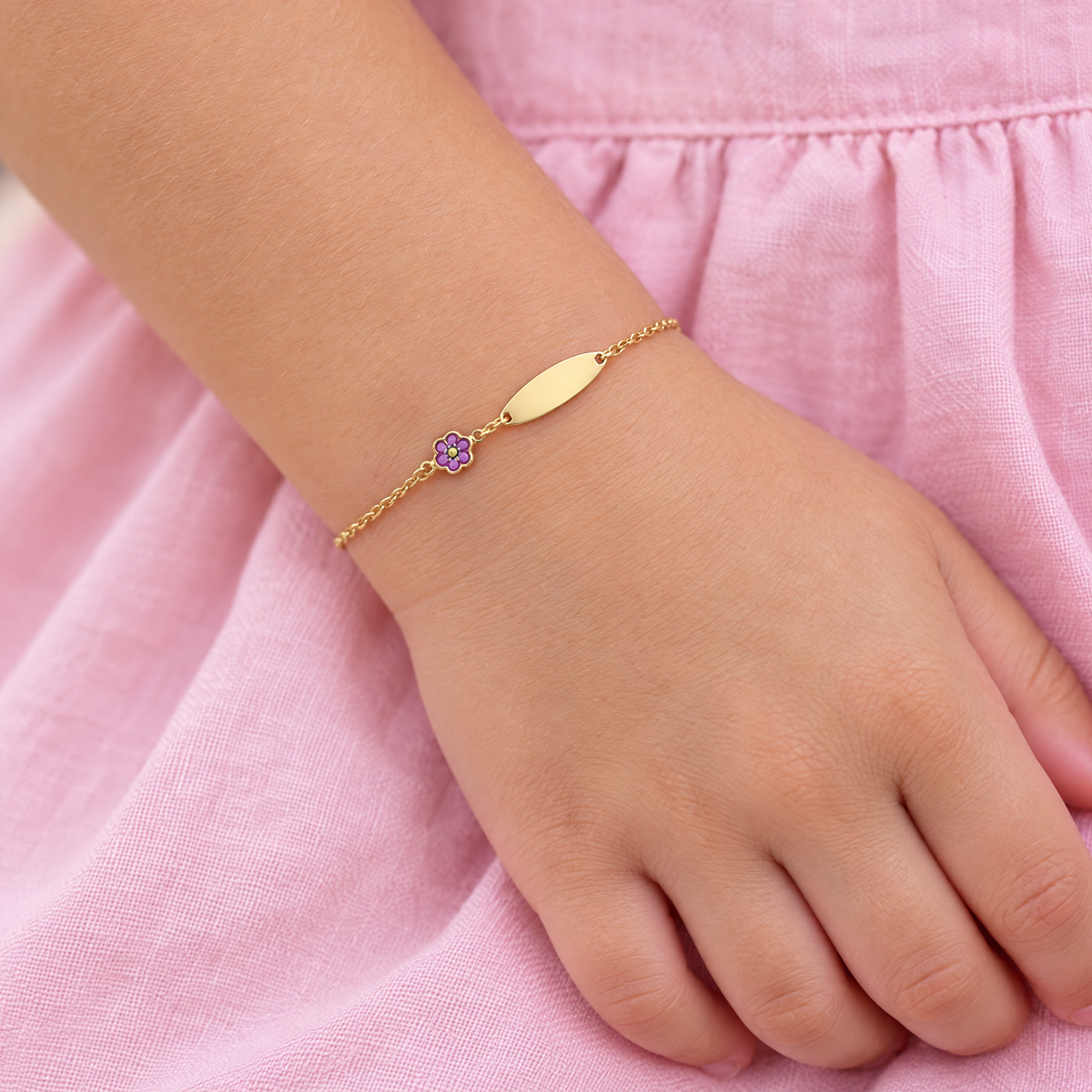 14K gold girls ID bracelet with a purple enamel flower charm, worn on a child's wrist, lifestyle photo, Gold Time