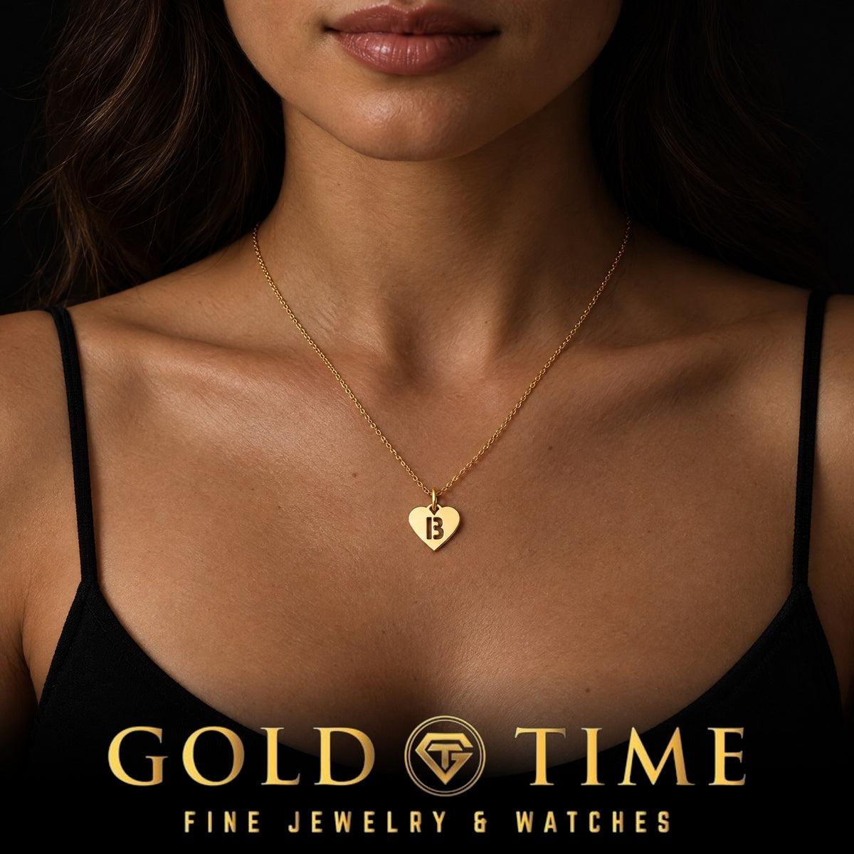 Woman wearing a yellow gold heart charm with a cut-out letter B on a dainty chain, Gold Time