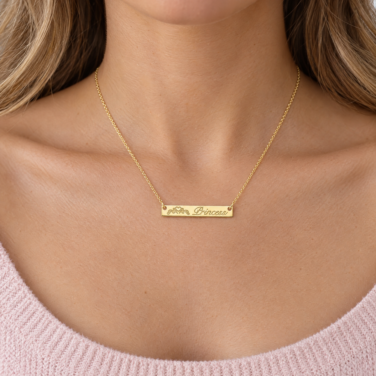 Yellow gold horizontal bar necklace engraved with a crown and Princess, worn by a young woman, lifestyle photo, Gold Time