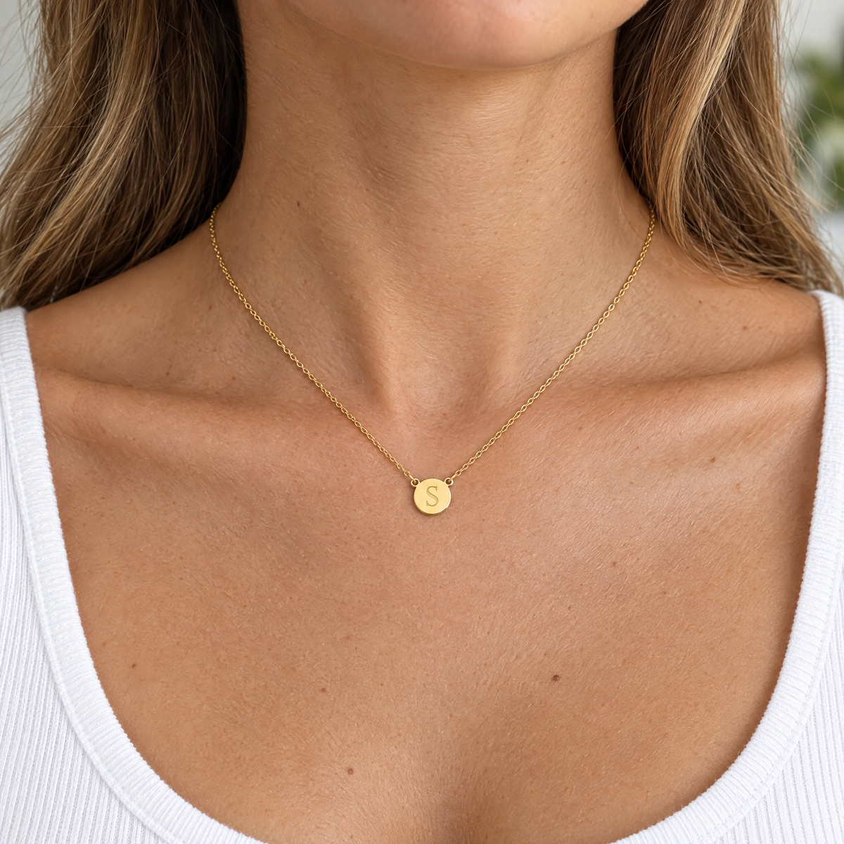 Yellow gold initial circle necklace with a block letter S, worn by a woman, lifestyle photo, Gold Time