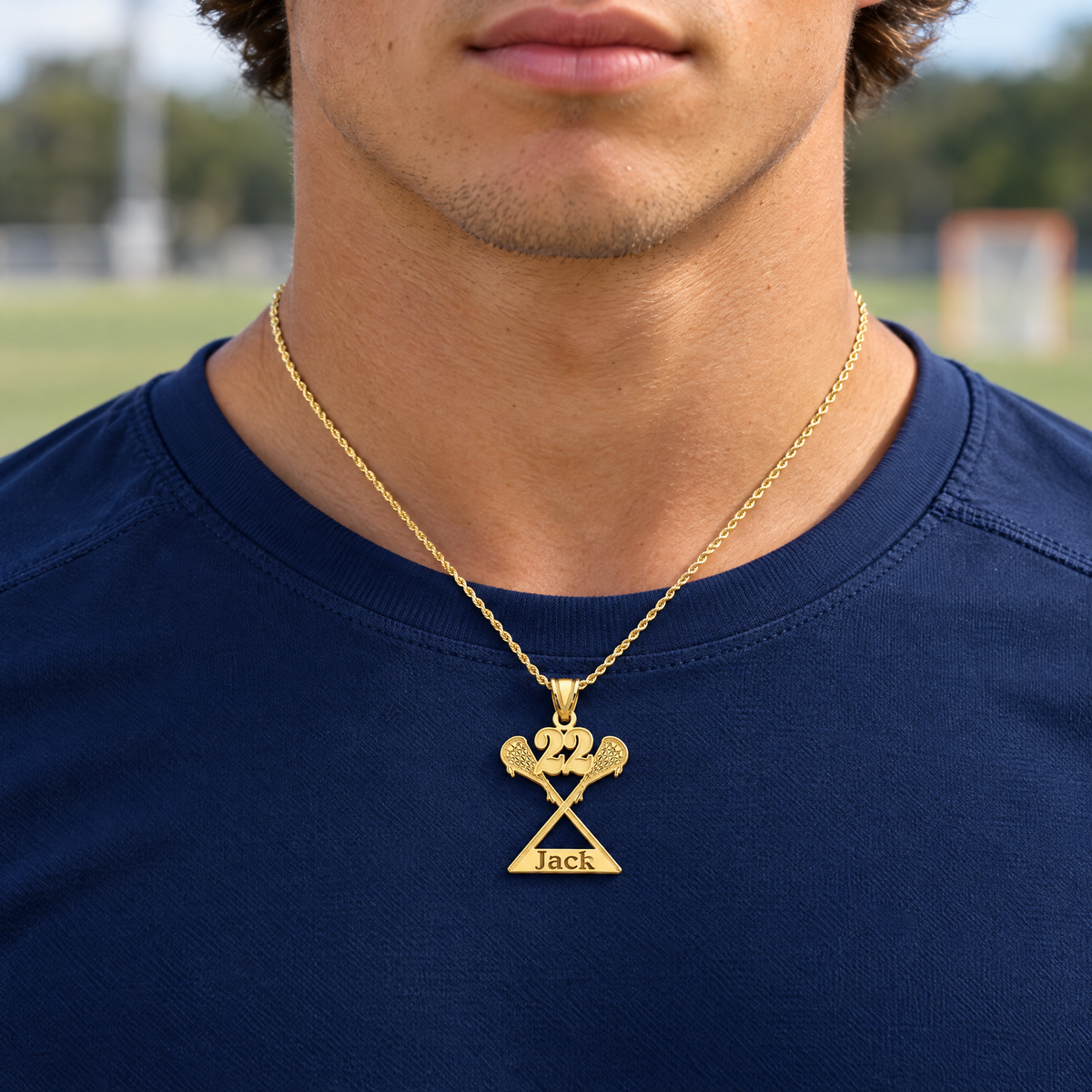 Yellow gold lacrosse pendant with number 22 and the name Jack, worn by a young man, lifestyle photo, Gold Time