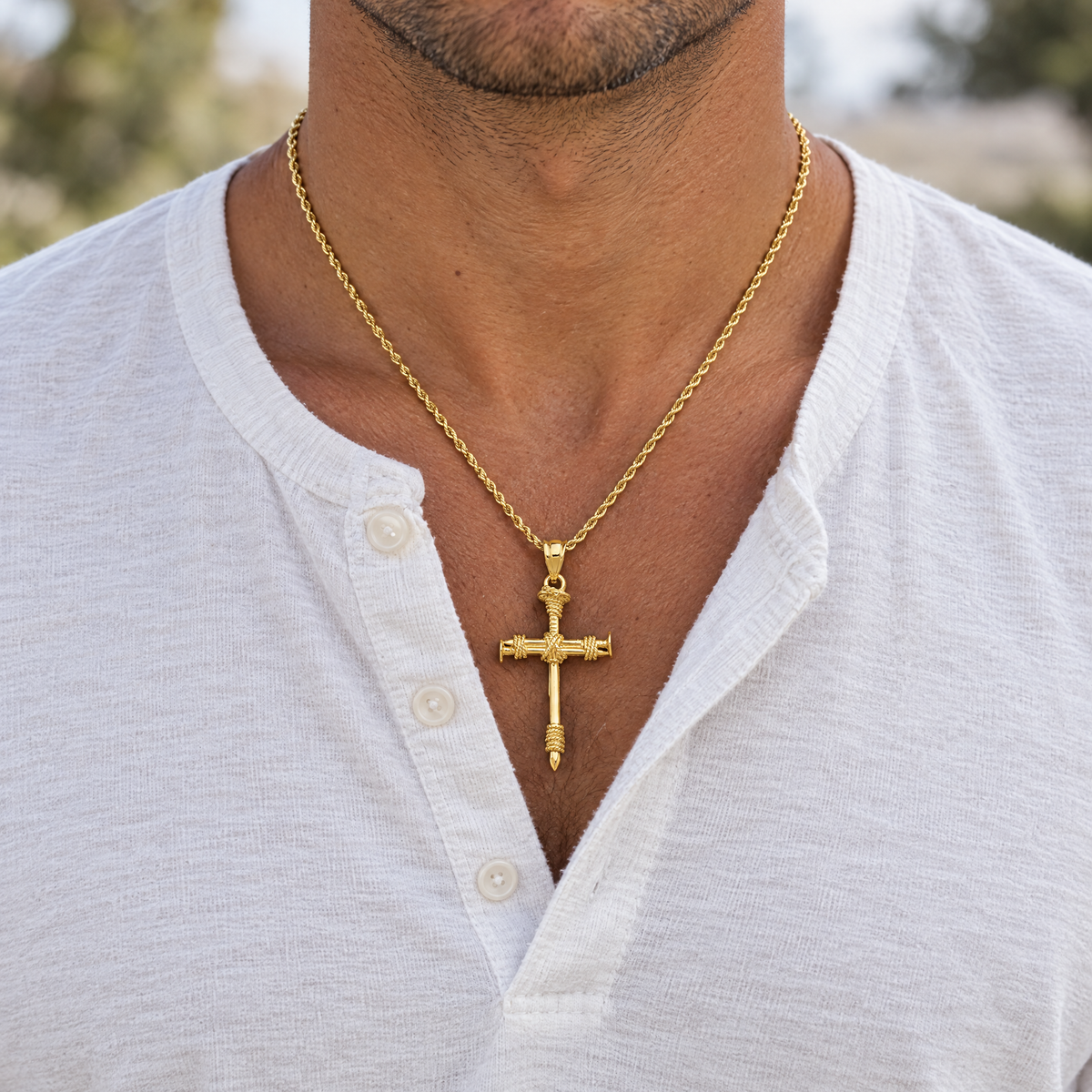 14K yellow gold nail cross pendant worn on a rope chain by a man, lifestyle photo, Gold Time
