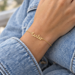 Yellow gold signature name bracelet reading Carlee, worn on a woman's wrist, lifestyle photo, Gold Time