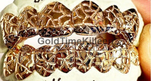 Close-up of a two tone nugget and diamond-cut top and bottom grill set on a mold