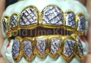 Twelve piece two-tone grill with yellow gold box frames shown on a green dental mold