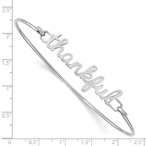 Sterling silver thankful bangle beside a ruler showing its size