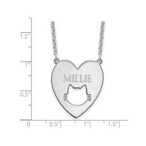 Sterling silver cat cutout heart pendant measured against a ruler at just over one inch
