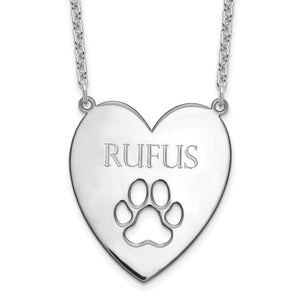 Close-up of sterling silver heart pendant engraved with a dog's name above a paw print cutout