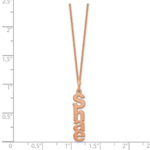 Rose gold single vertical name charm necklace against an inch scale for size reference