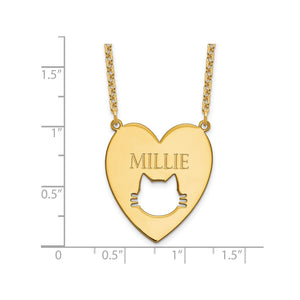 Gold plated cat cutout heart pendant measured against a ruler at just over one inch