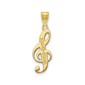 Yellow gold treble clef pendant with a name engraved down the stem, on a white background