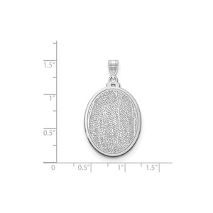 White gold or silver fingerprint pendant against an inch scale for size reference