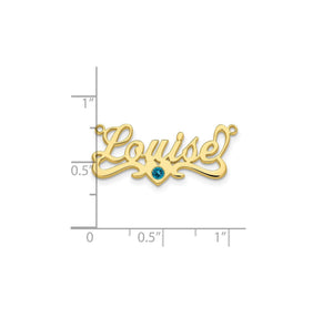 Louise birthstone nameplate against an inch scale for size reference