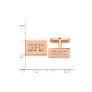 Rose plated rectangle monogram cuff links beside a ruler for scale