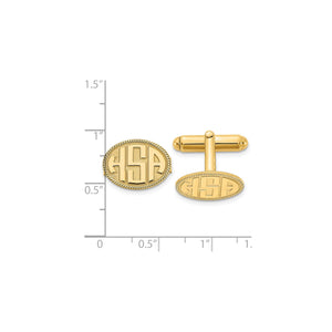 Yellow rope border monogram cuff links against an inch ruler