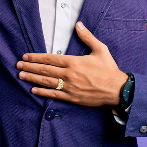 Man in a navy suit wearing the 14k gold channel set diamond ring