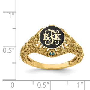 Yellow gold floral monogram birthstone ring against an inch scale for size reference