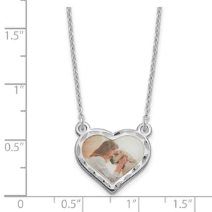 Sterling silver heart photo pendant measured against a ruler at about three quarters of an inch