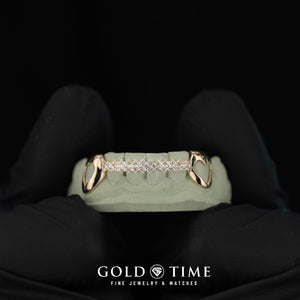 Gold heart grillz with diamonds on a green mold, held by a gloved hand against a black background, with 'Gold Time' branding.