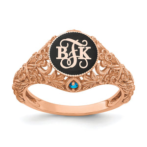 Rose gold floral monogram ring with raised initials on black enamel and a birthstone below the face