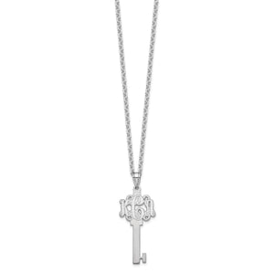 White gold monogram key pendant hanging from its chain against a plain background