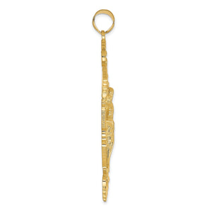 Edge view of the gold INRI crucifix pendant showing its thickness and bail