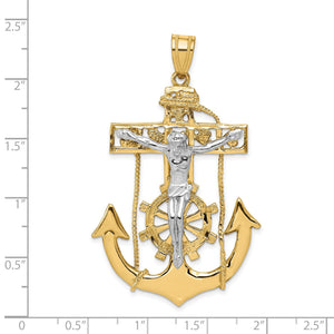 Two-tone mariner crucifix pendant measured against a ruler, about two and a quarter inches tall