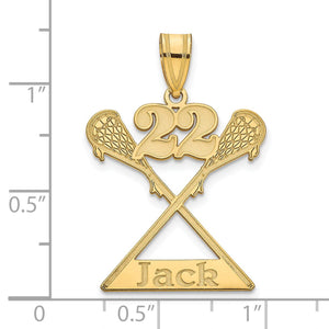 Yellow gold lacrosse pendant next to a ruler for scale
