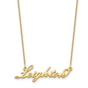 Cursive script name necklace worn on a mannequin bust, shown on a dark background