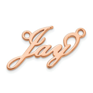 Close up of a yellow gold cursive script nameplate showing the connected letters and curled tail
