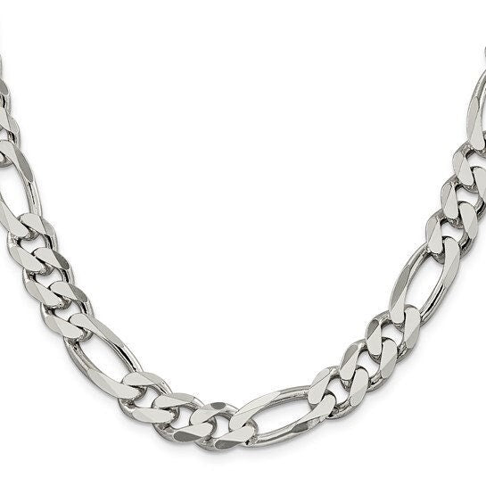 Close up of a wide sterling silver Figaro chain showing three short links and one long link